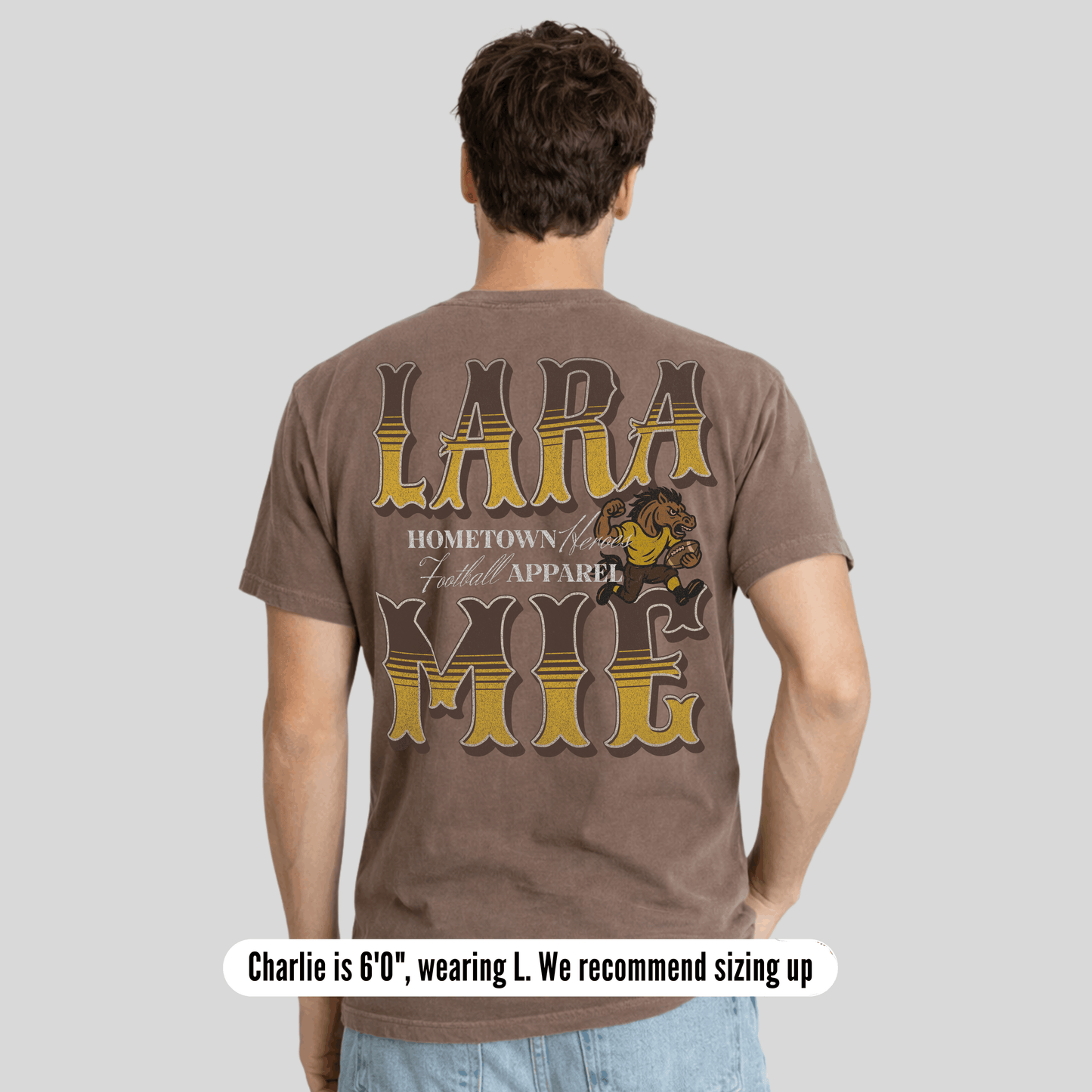 Man wearing a brown t-shirt with 'LARA HOME' text and graphics on the back, on a light gray background.