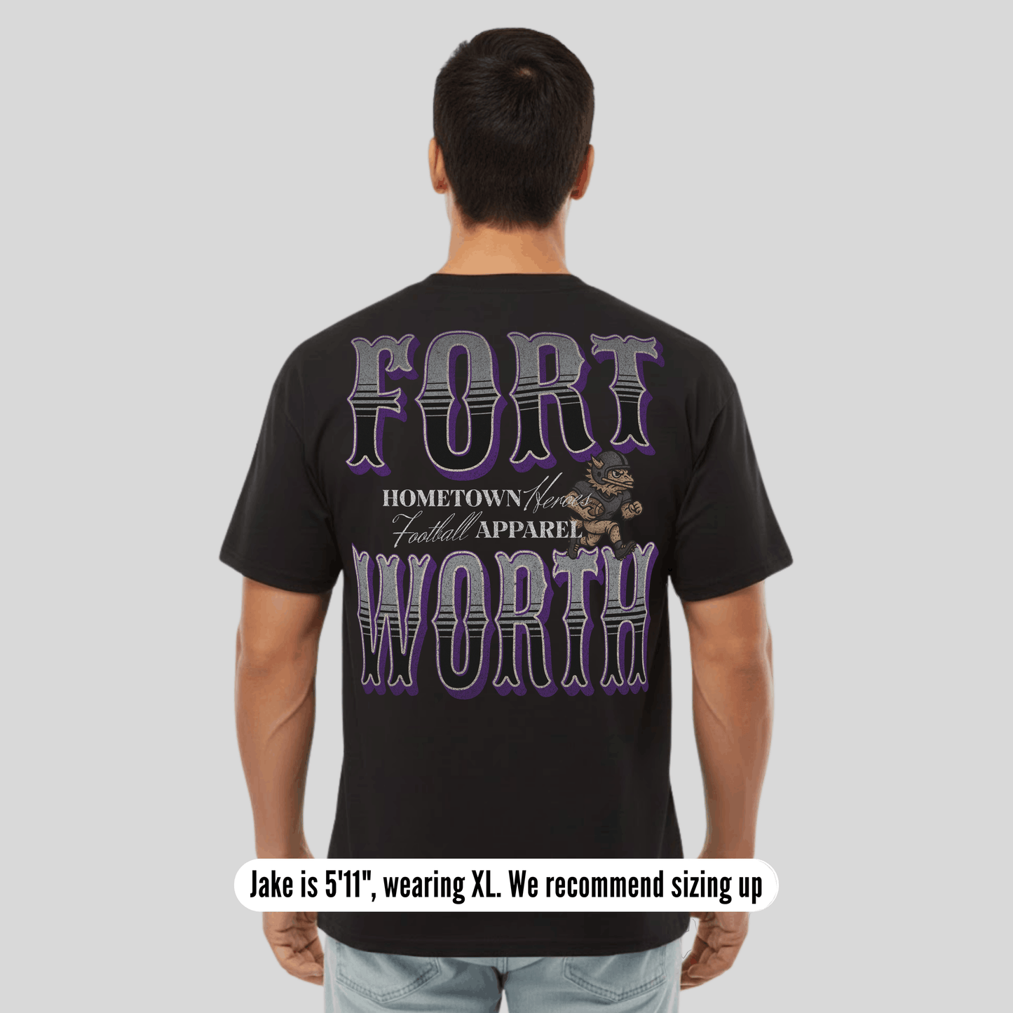 Person wearing a black t-shirt with 'Fort Worth' text and graphic on the back, on a plain background.