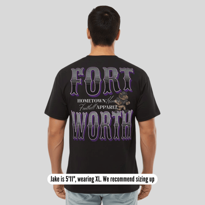 Person wearing a black t-shirt with 'Fort Worth' text and graphic on the back, on a plain background.