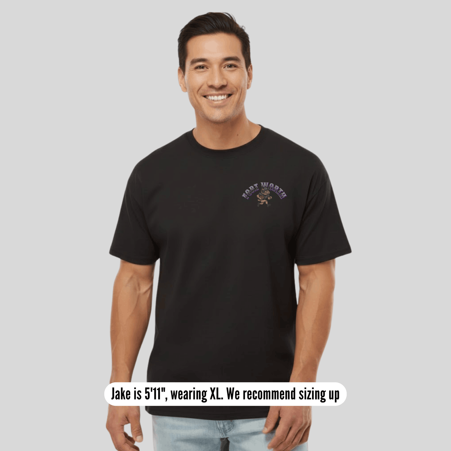 Man wearing a black t-shirt with a logo on a gray background