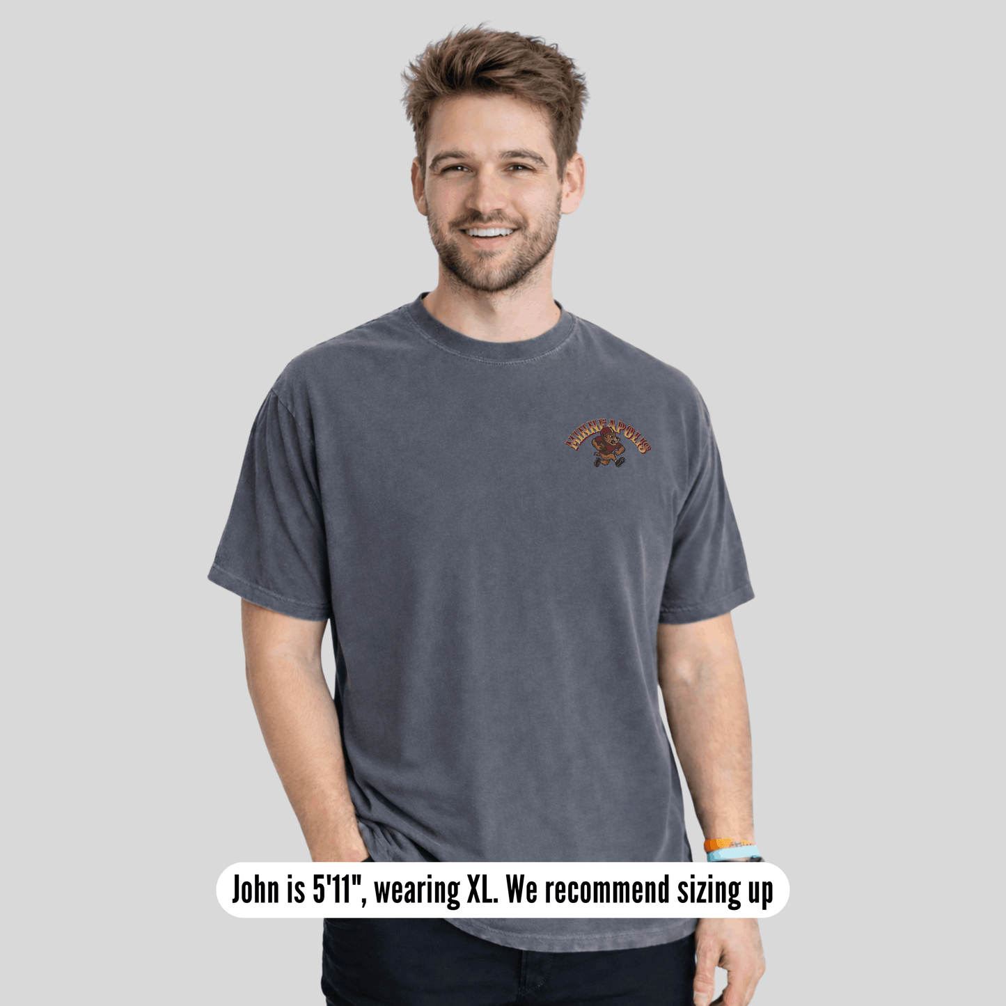 Man wearing a gray t-shirt with a logo on a light gray background