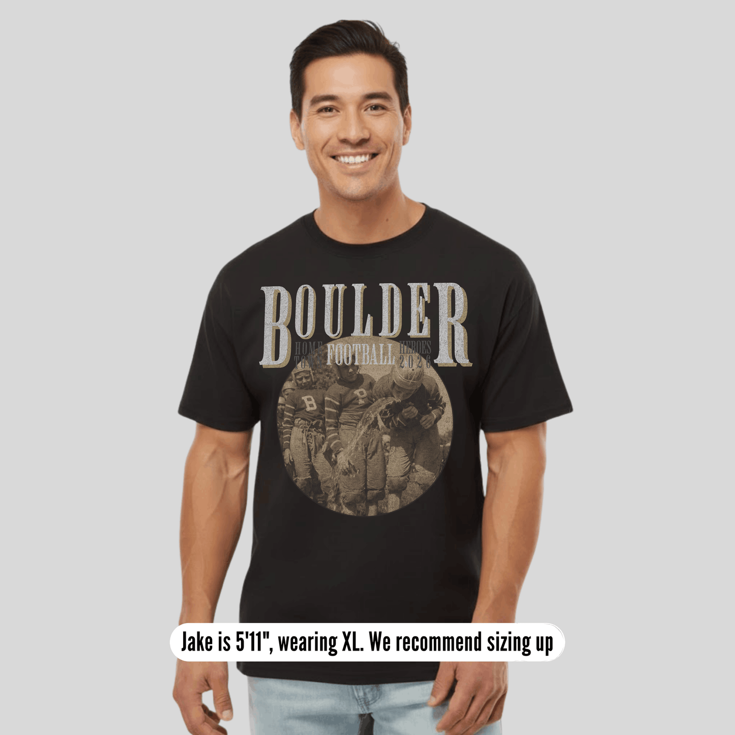 Man wearing a black t-shirt with 'BOULDER' printed on it, standing against a plain background.