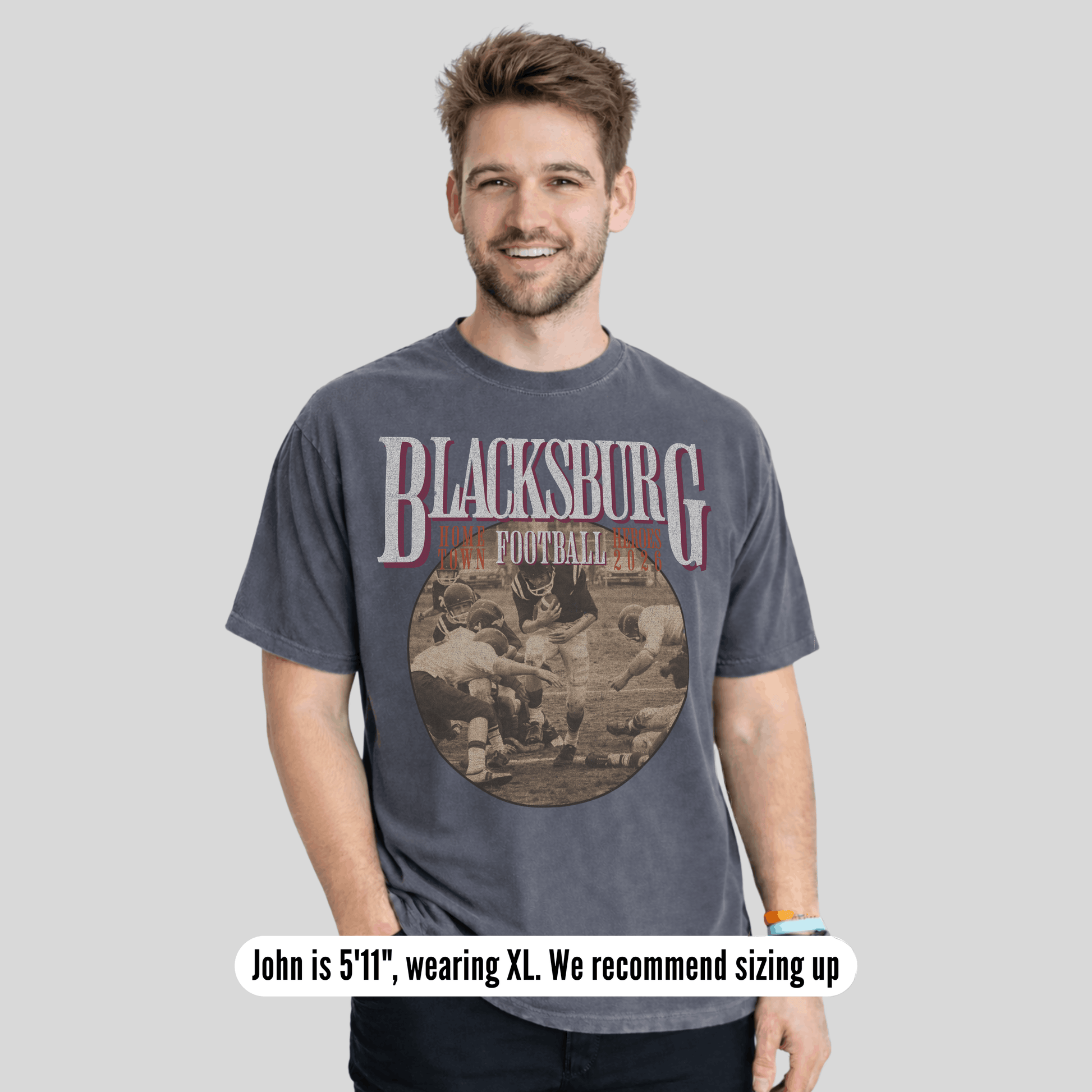 Man wearing a 'Blacksburg Football' t-shirt on a gray background