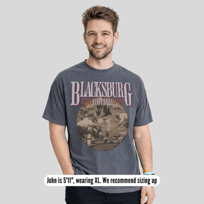 Man wearing a 'Blacksburg Football' t-shirt on a gray background
