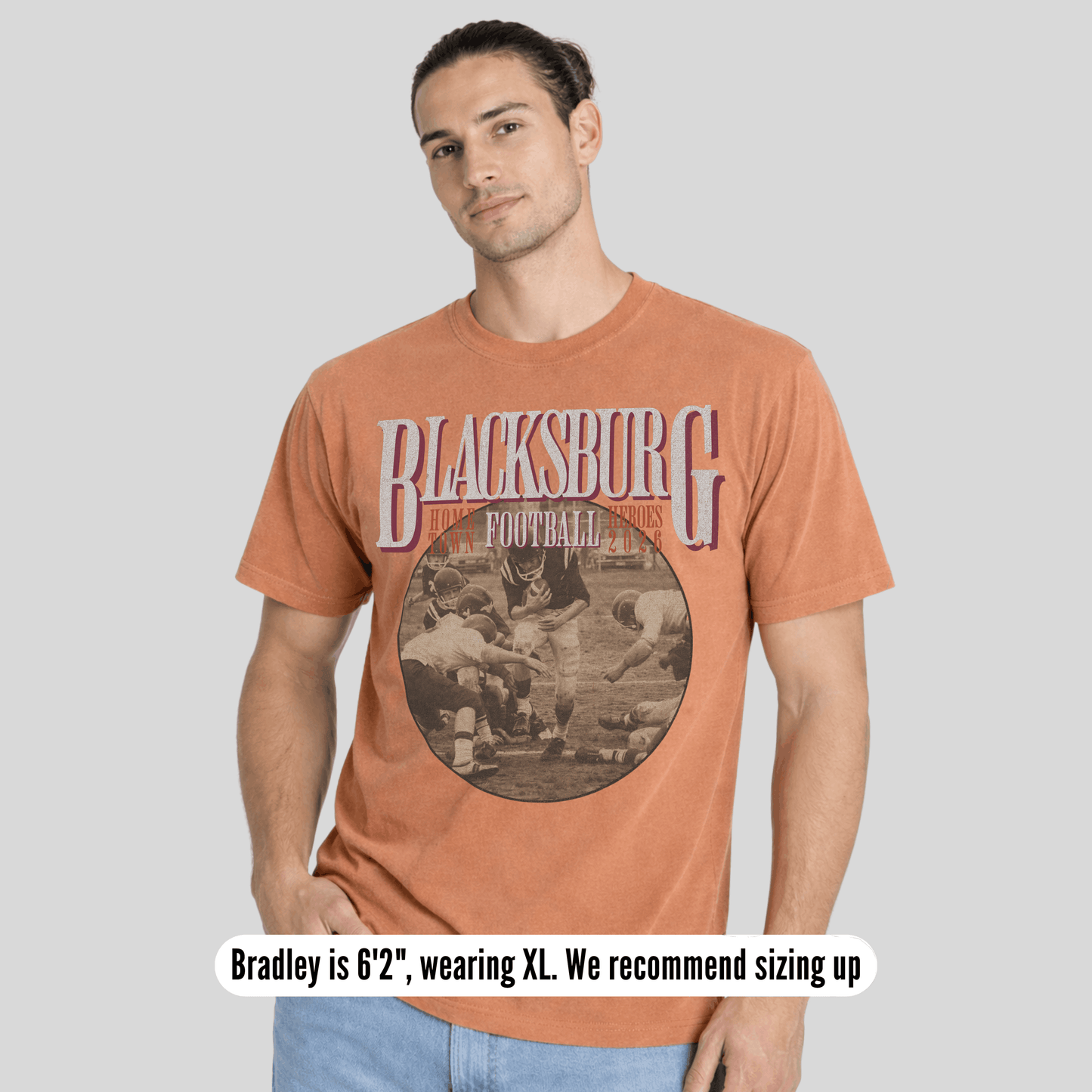 Man wearing a t-shirt with 'Blacksburg Football' graphic on a plain background