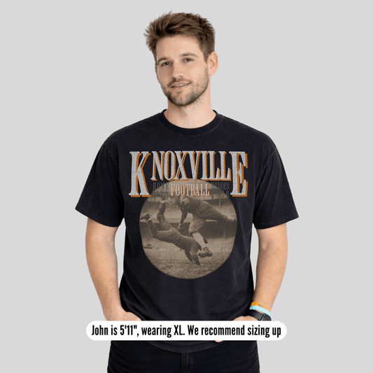Man wearing a black t-shirt with 'Knoxville Football' design on a gray background