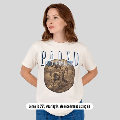 Woman wearing a white t-shirt with 'PROVO' and football graphic on a plain background