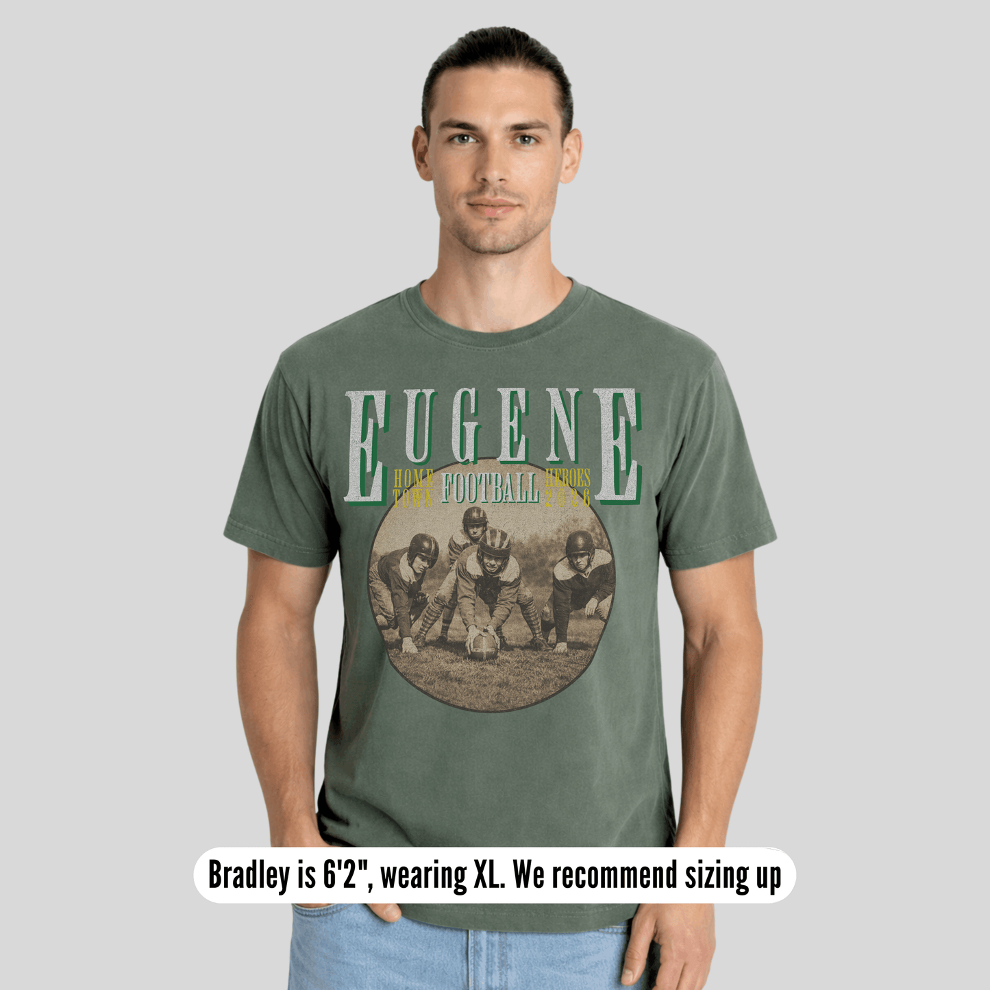 Man wearing a green t-shirt with 'Eugene Football' design on a gray background