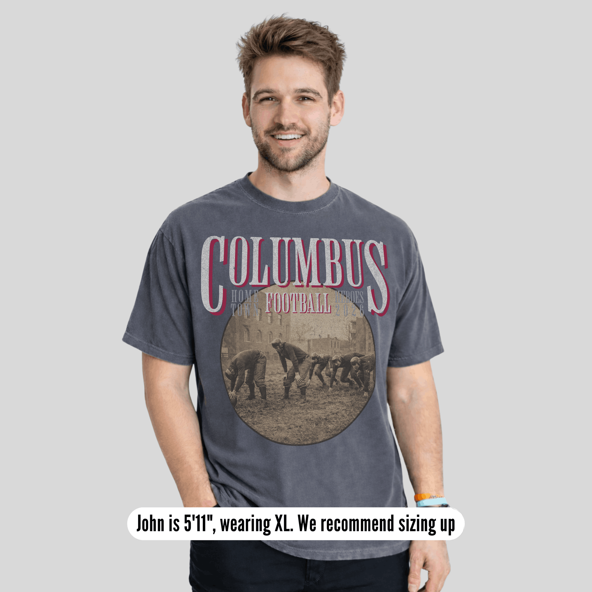 Man wearing a 'Columbus Football' t-shirt on a gray background