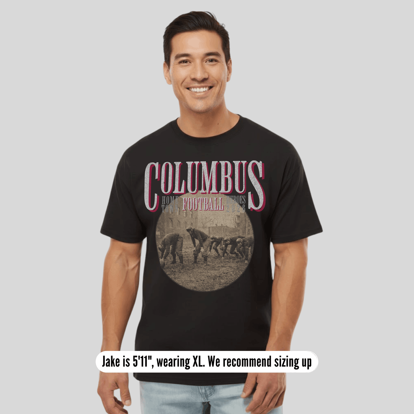 Man wearing a black t-shirt with 'Columbus' printed on it, standing against a plain background.