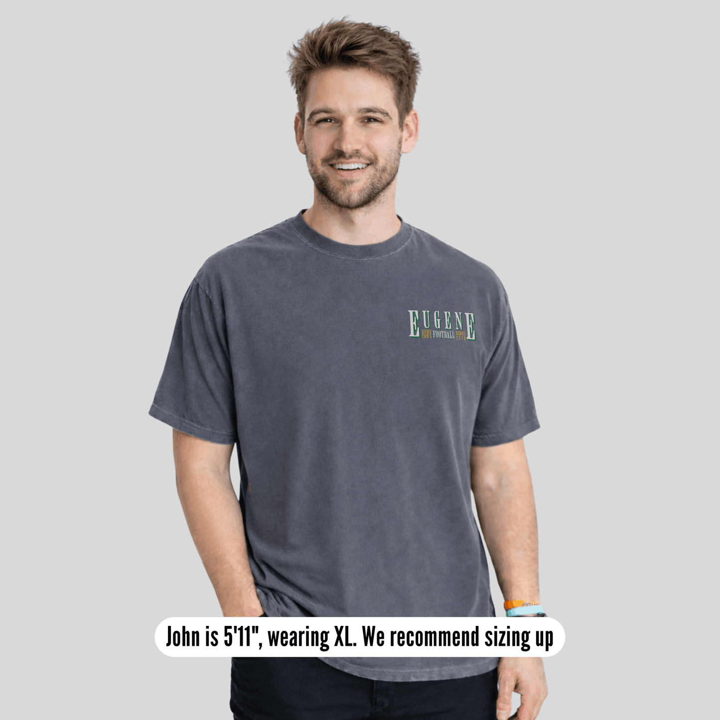 Man wearing a gray t-shirt with 'Eugene' text on a light gray background