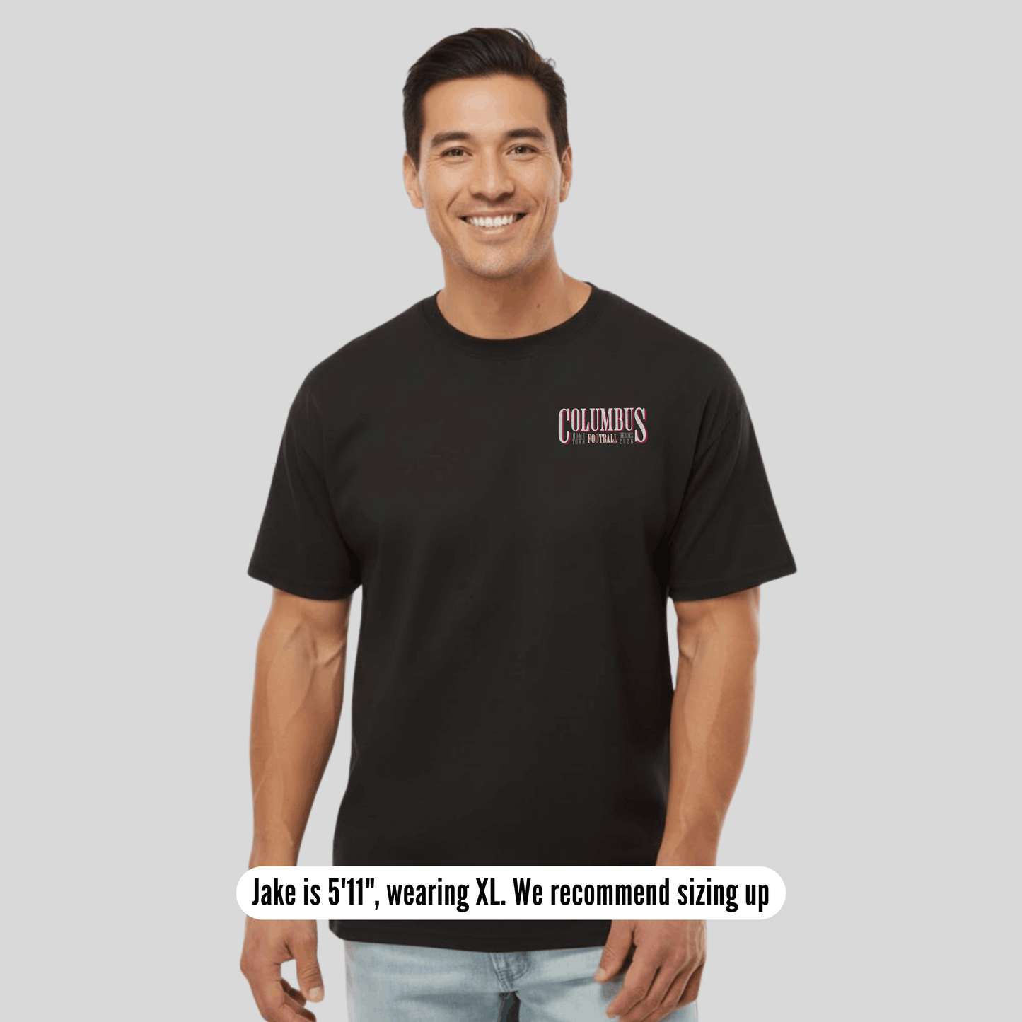 Man wearing a black t-shirt with text, standing against a plain background