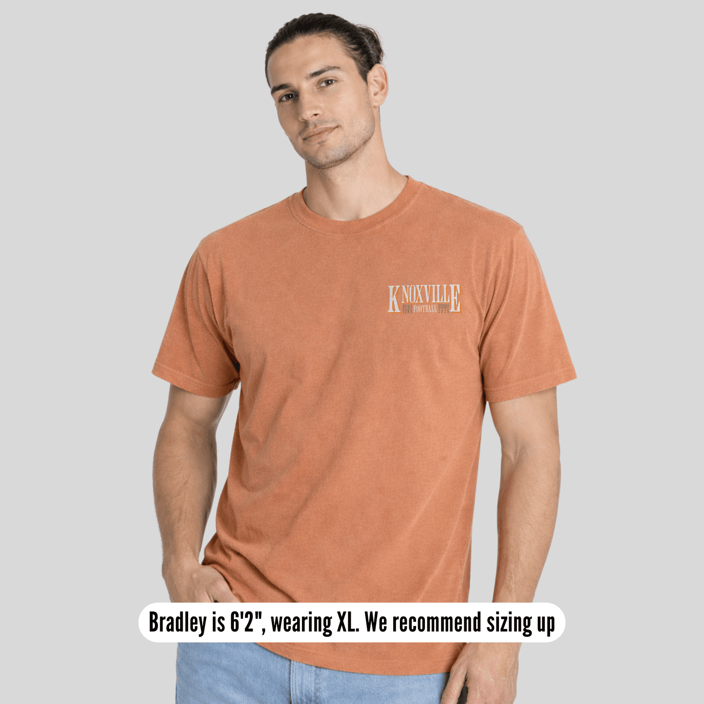 Man wearing a brown t-shirt with 'Knoxville' text on a gray background