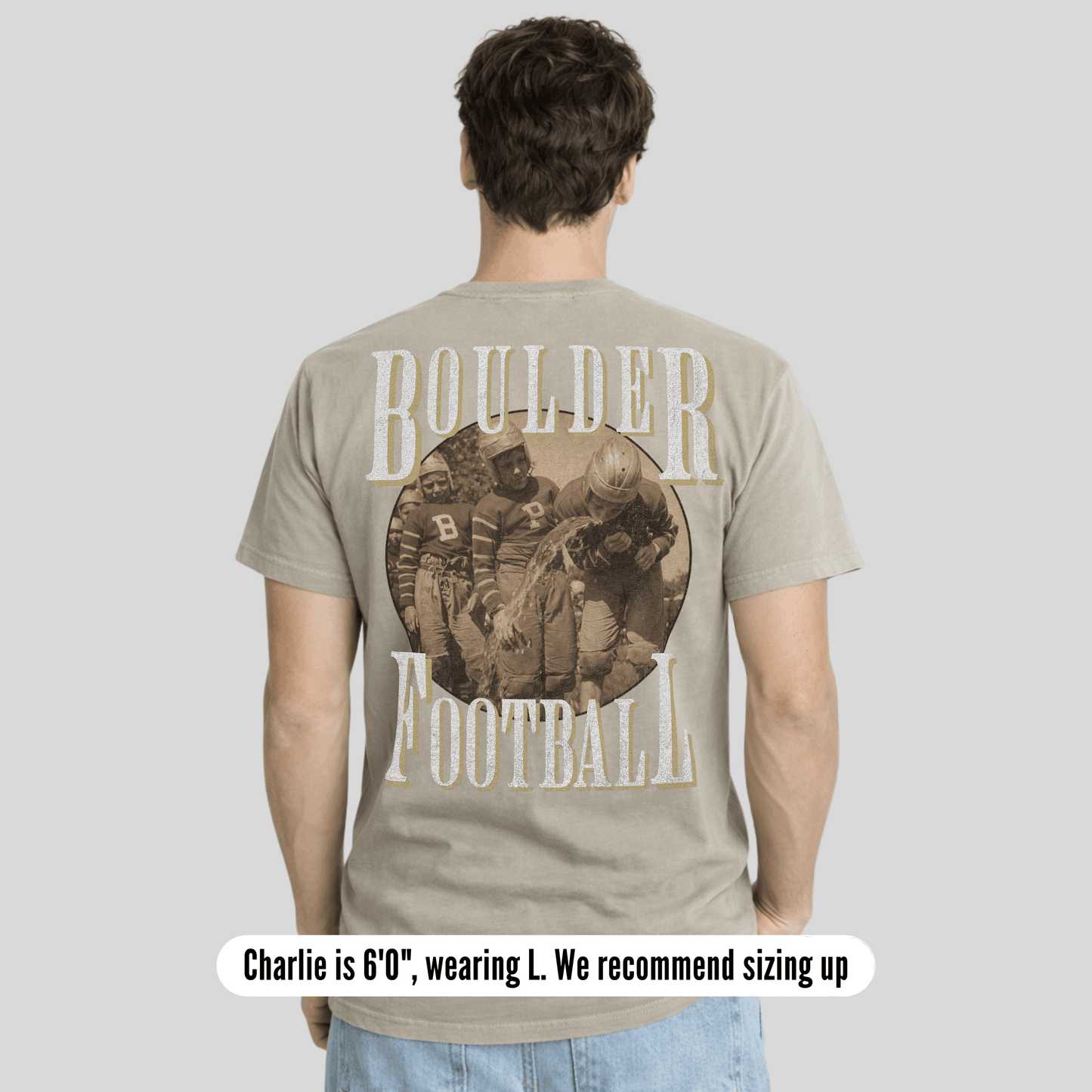 Person wearing a t-shirt with 'Boulder Football' design on the back, standing against a plain background.