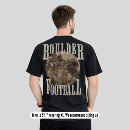 Man wearing a black t-shirt with 'Boulder Football' design on the back, standing against a plain background.