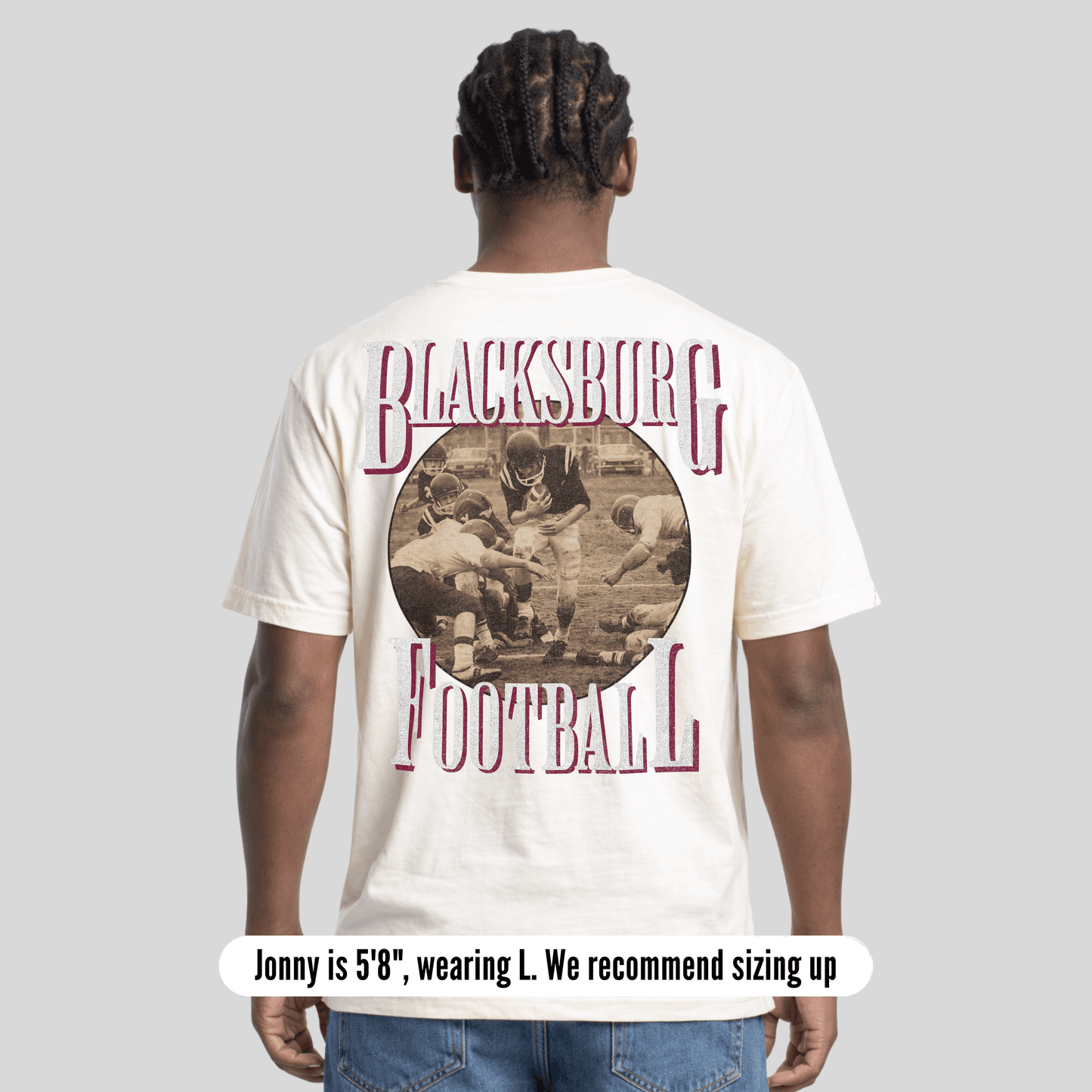 Person wearing a 'Blacksburg Football' t-shirt with a vintage-style graphic on the back.