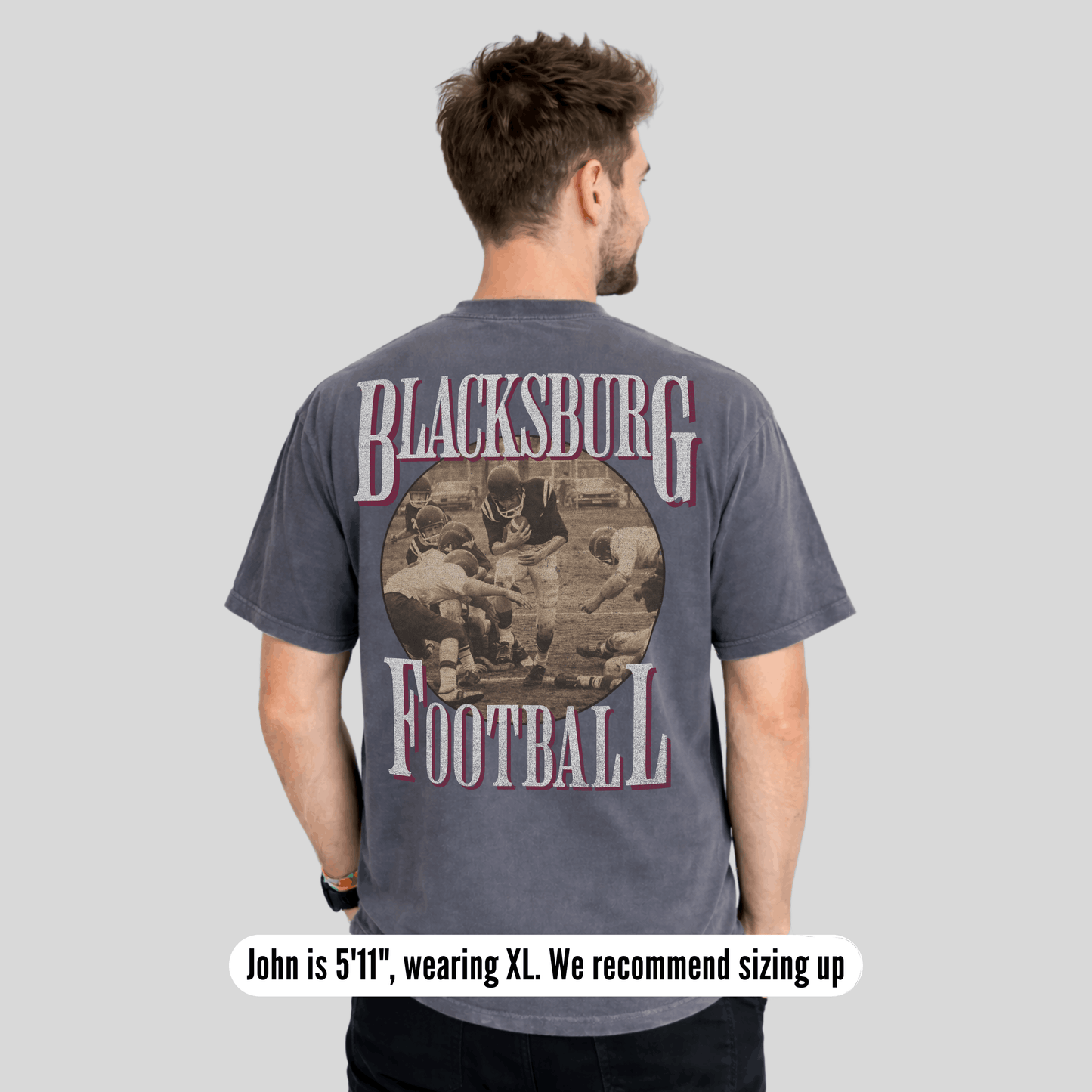 Man wearing a 'Blacksburg Football' t-shirt with a graphic on the back against a gray background