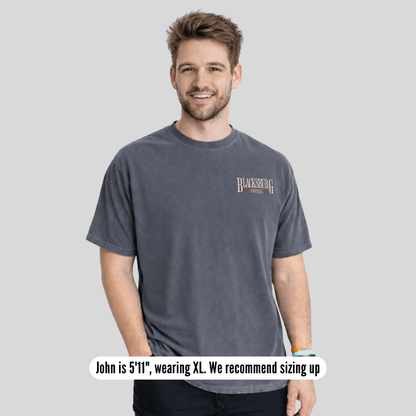 Man wearing a gray t-shirt with text on a plain background