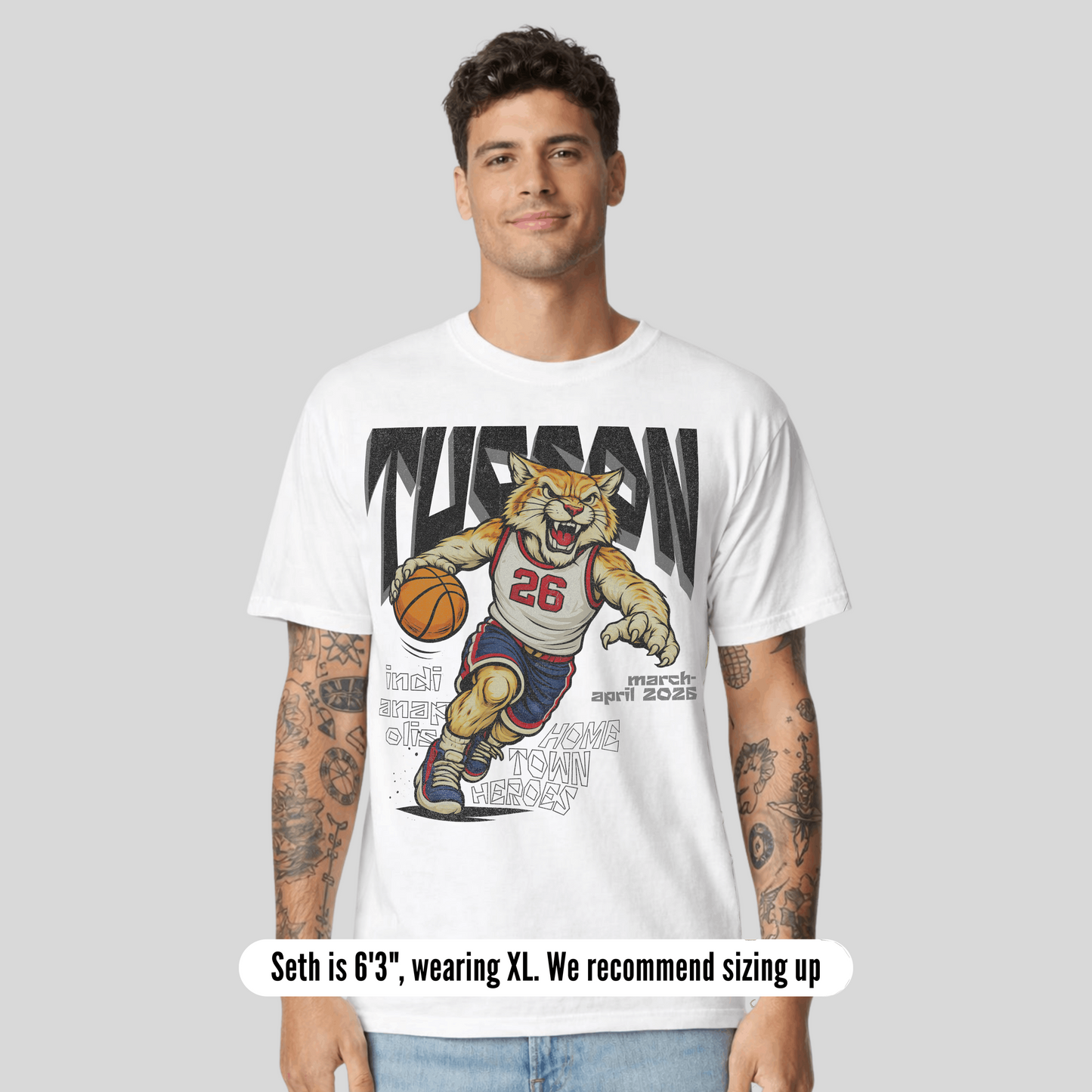 Man wearing a white t-shirt with a graphic of a tiger playing basketball and text.