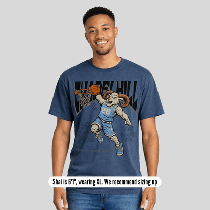 Man wearing a blue t-shirt with a graphic design of a ram playing basketball, on a plain background.