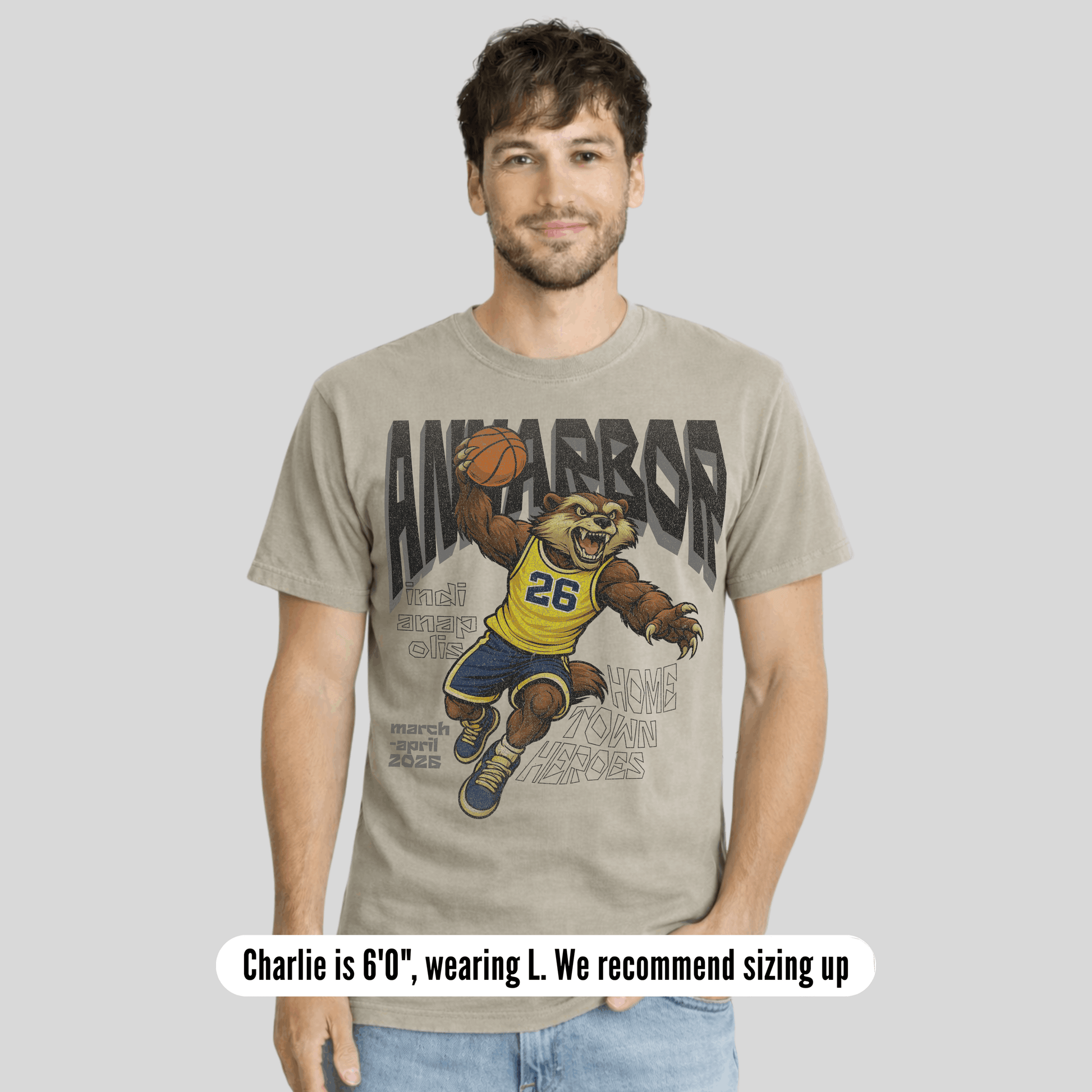 Man wearing a t-shirt with a bear holding a basketball graphic and text.