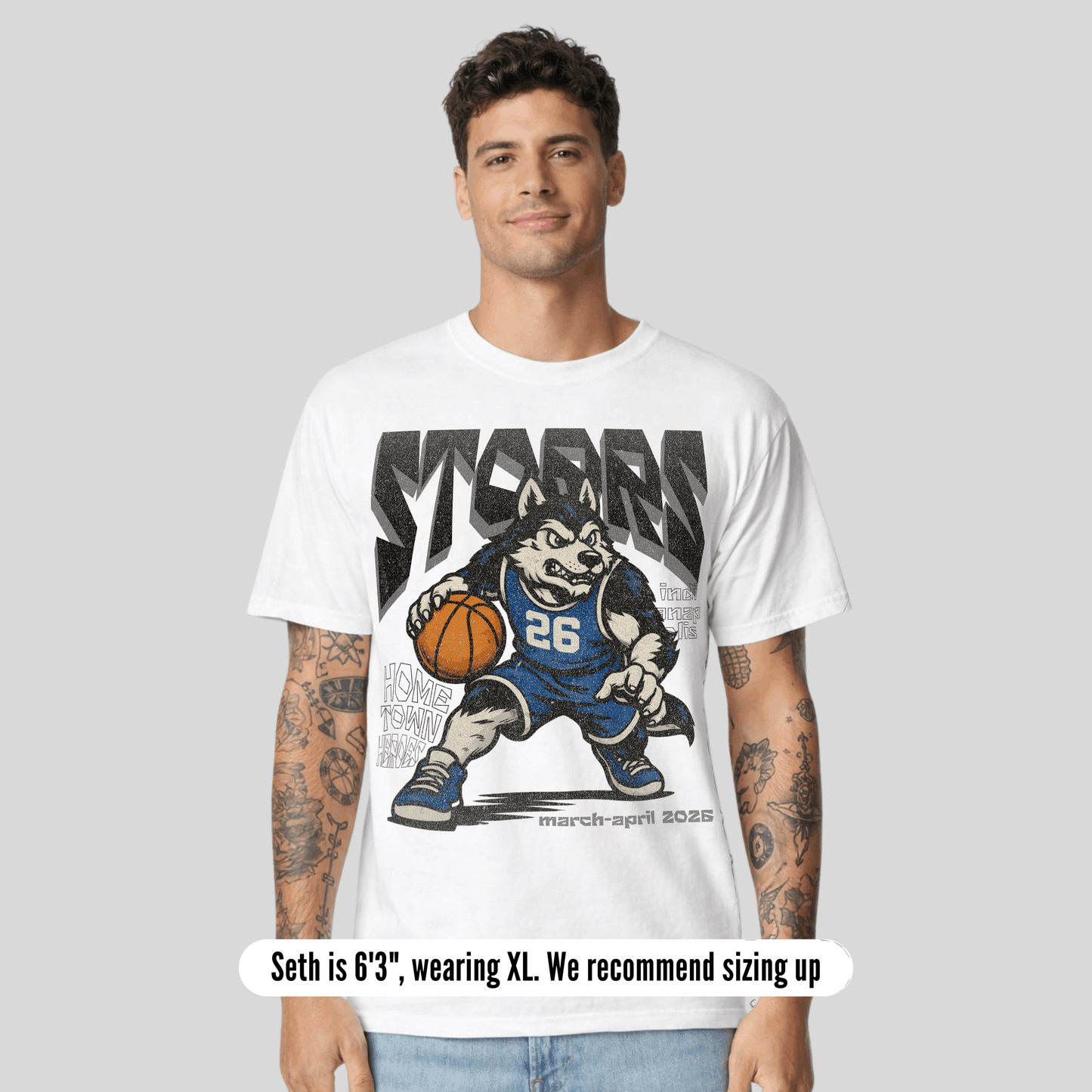 Man wearing a white t-shirt with a graphic design of a wolf holding a basketball and text.