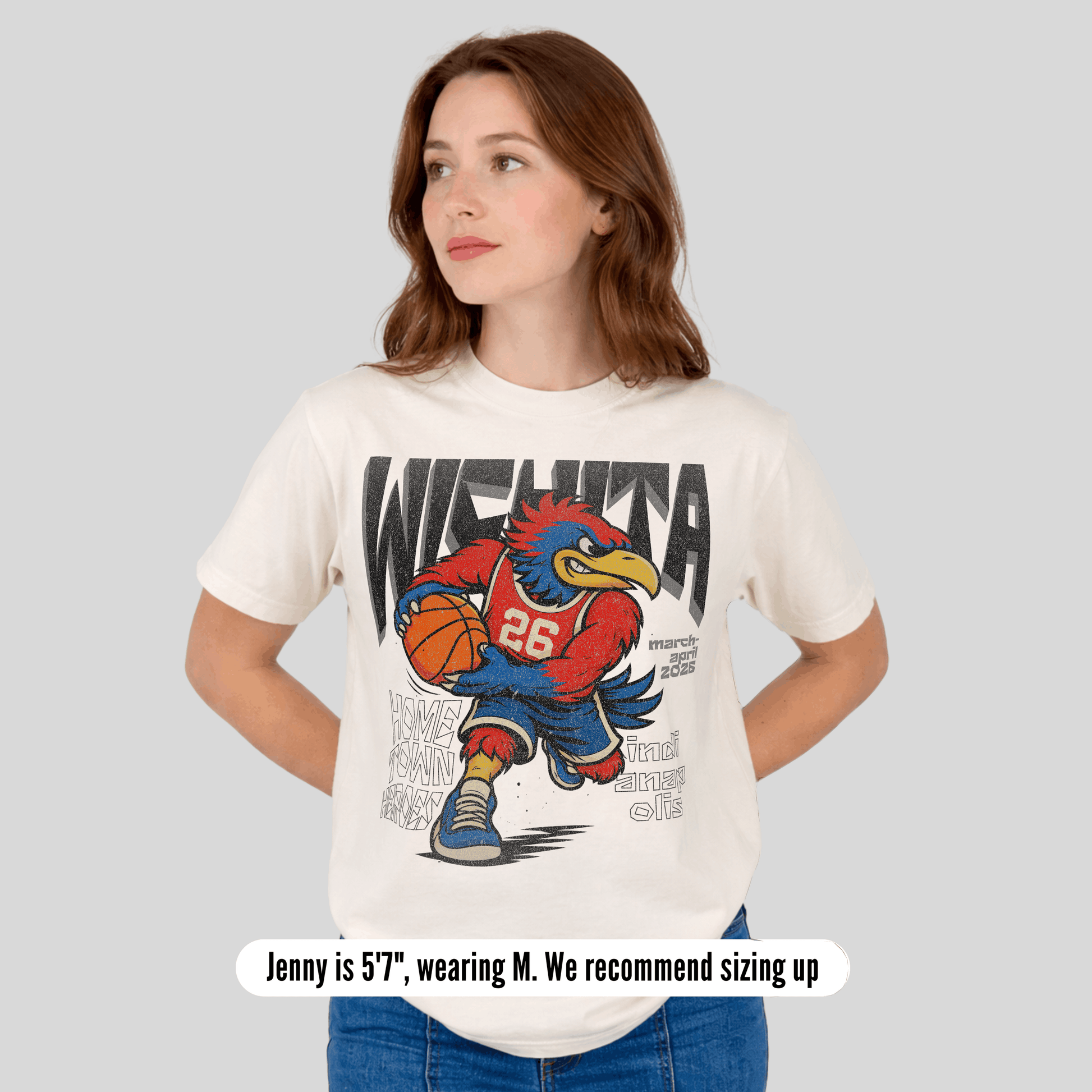 Woman wearing a white t-shirt with a graphic design of a cartoon character holding a basketball on a gray background.