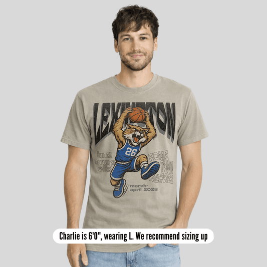 Man wearing a t-shirt with a graphic design of a tiger holding a basketball and text.