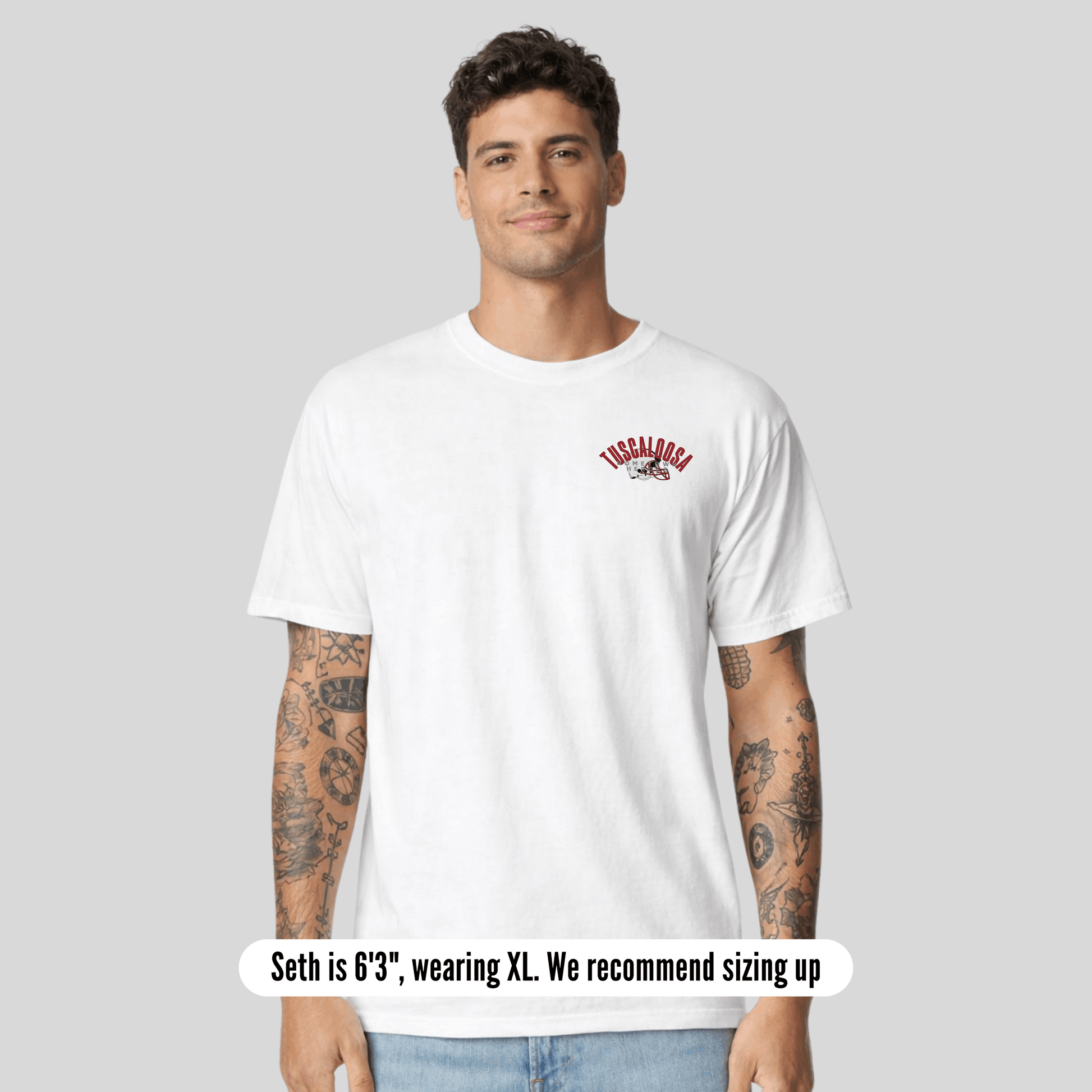 Man wearing a white t-shirt with a logo on a gray background