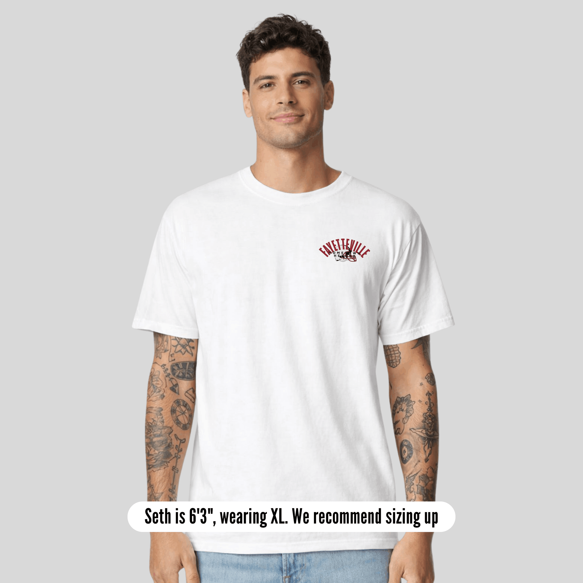 Man wearing a white t-shirt with a logo on a gray background