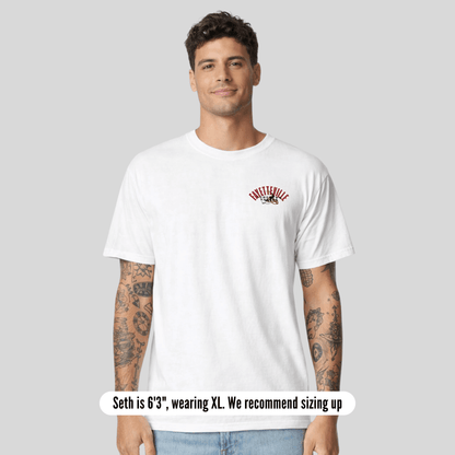 Man wearing a white t-shirt with a logo on a gray background
