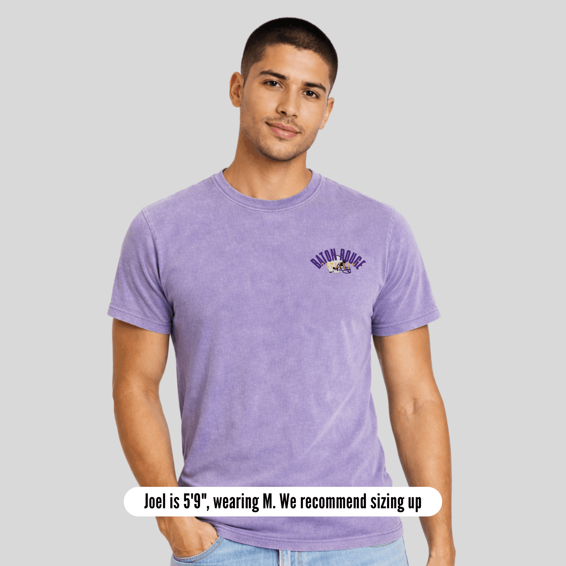 Man wearing a purple t-shirt with text on a gray background