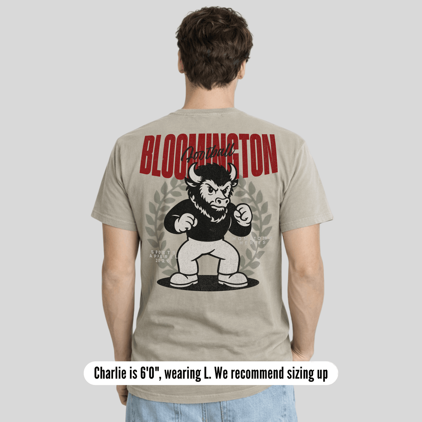 Person wearing a t-shirt with a graphic design and text on the back, on a plain background.