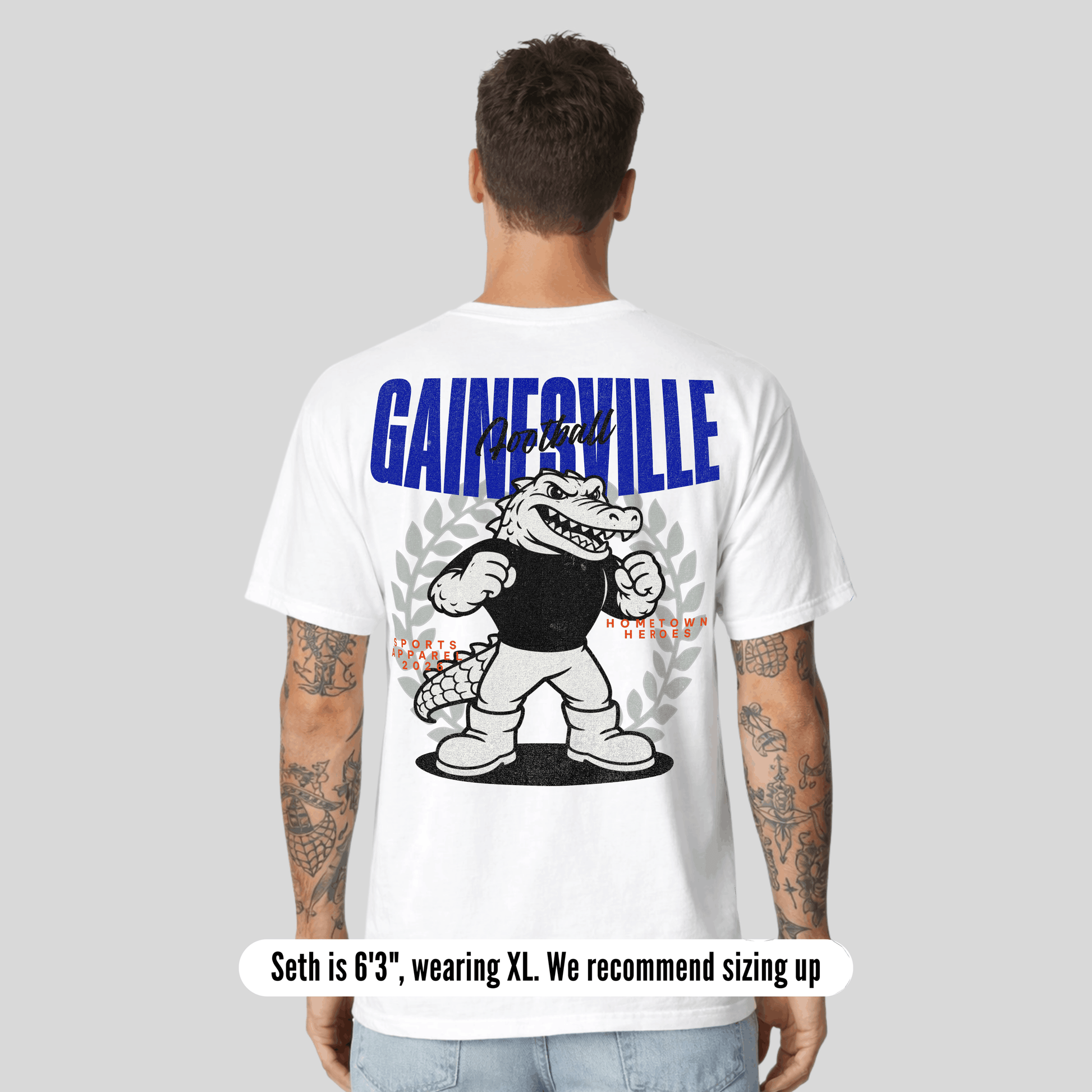 Person wearing a white t-shirt with 'Gainesville' graphic on the back, on a gray background.