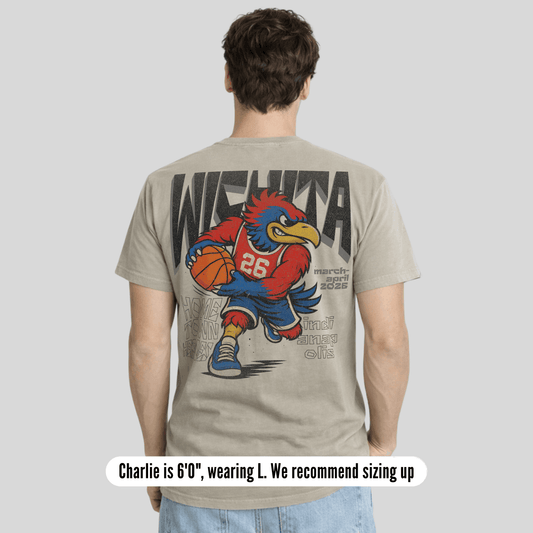 Person wearing a t-shirt with a graphic design on the back, featuring a mascot holding a basketball.