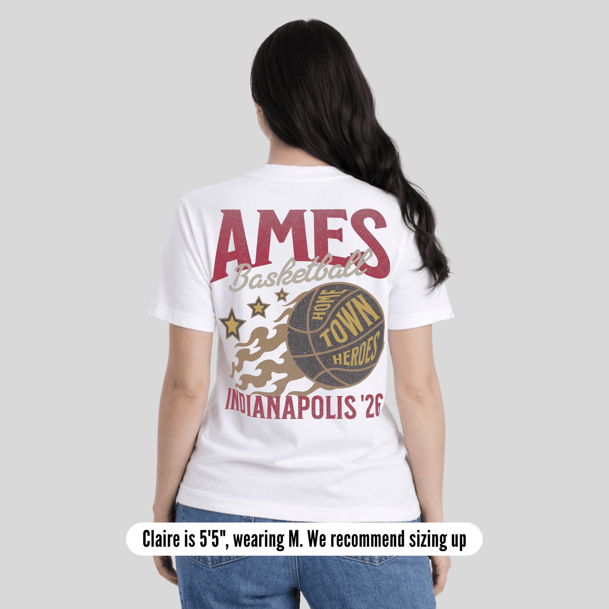 Person wearing a white t-shirt with 'AMES Basketball Town Hero Indianapolis 26' design on a plain background