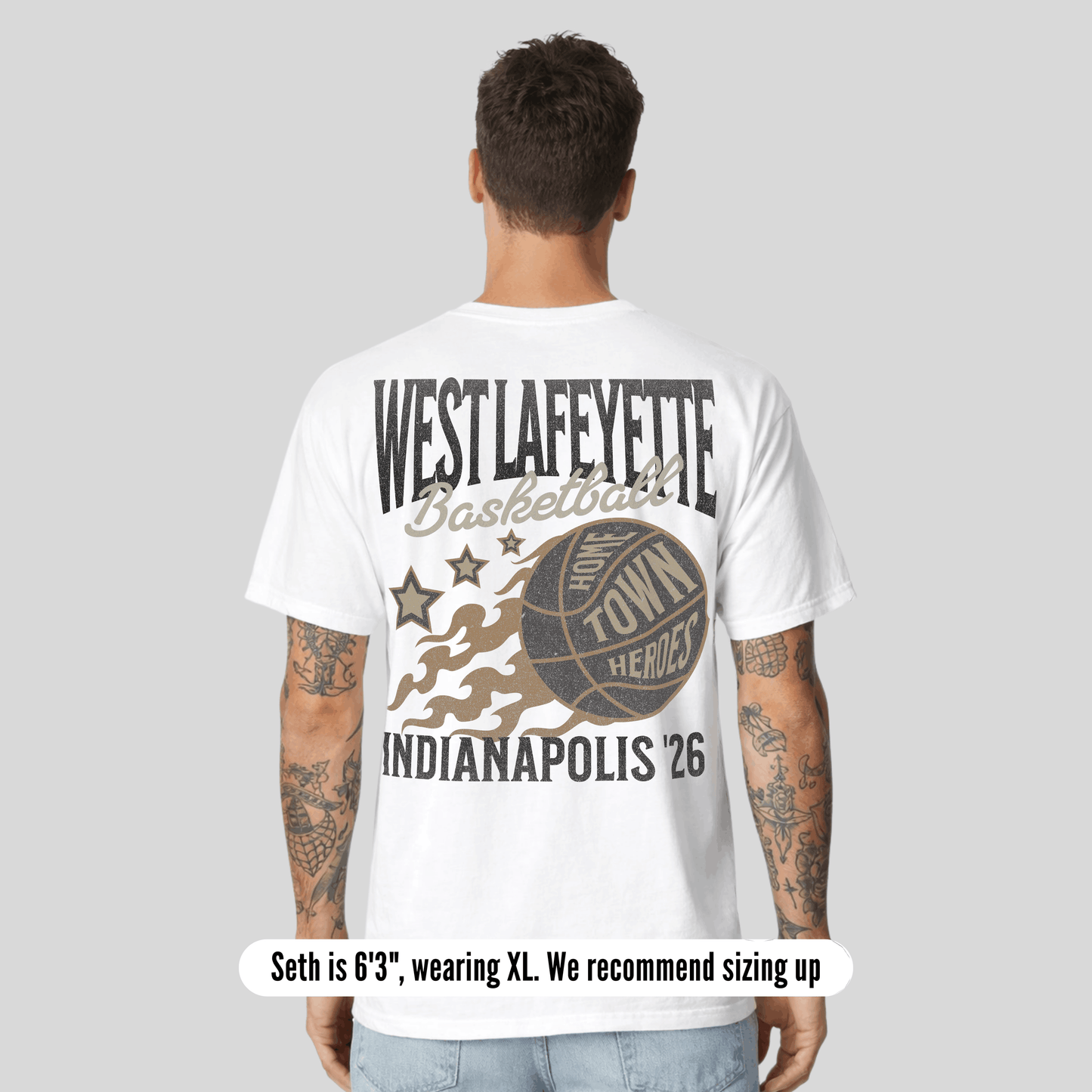 Person wearing a white t-shirt with 'West Lafayette Basketball' design on the back, standing against a gray background.