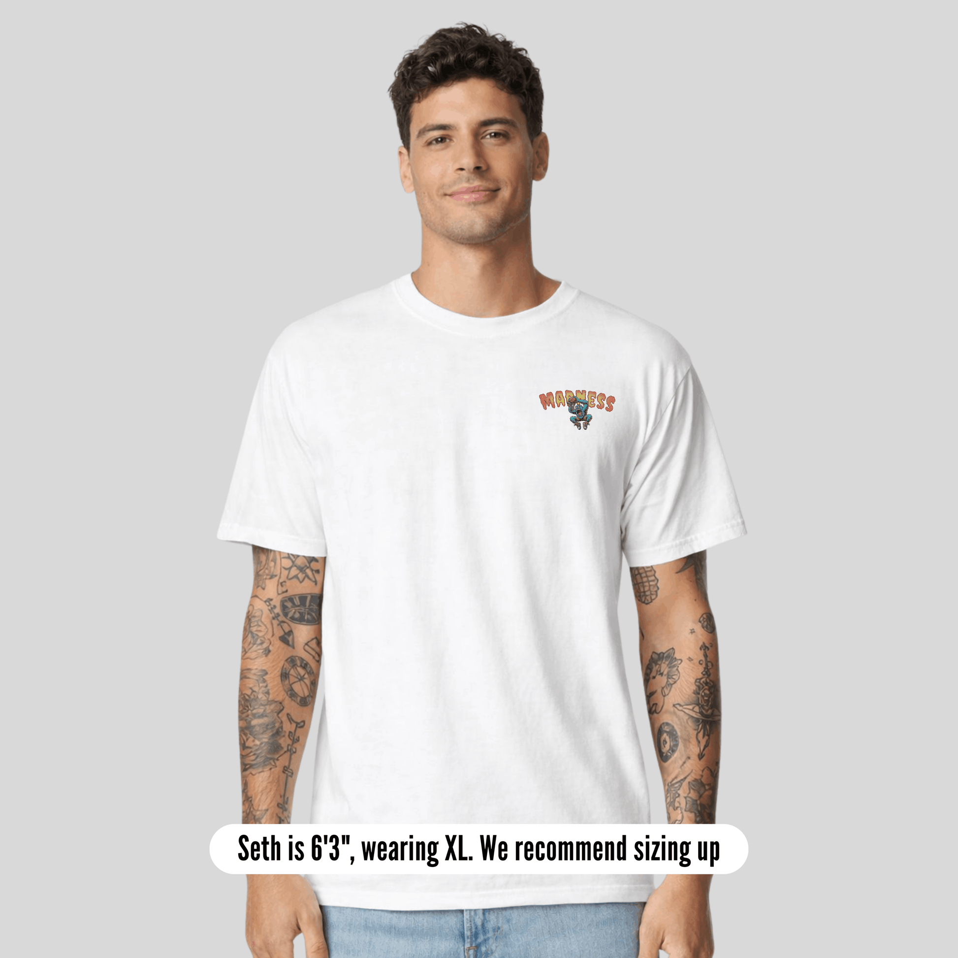 Man wearing a white t-shirt with text on a gray background