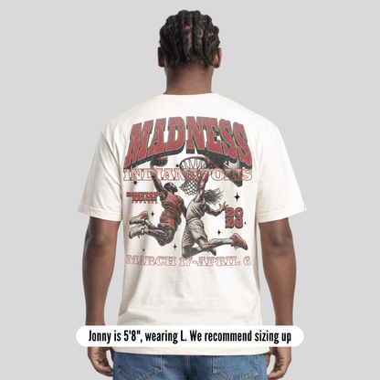 Person wearing a white t-shirt with graphic design and text on the back, on a light gray background.