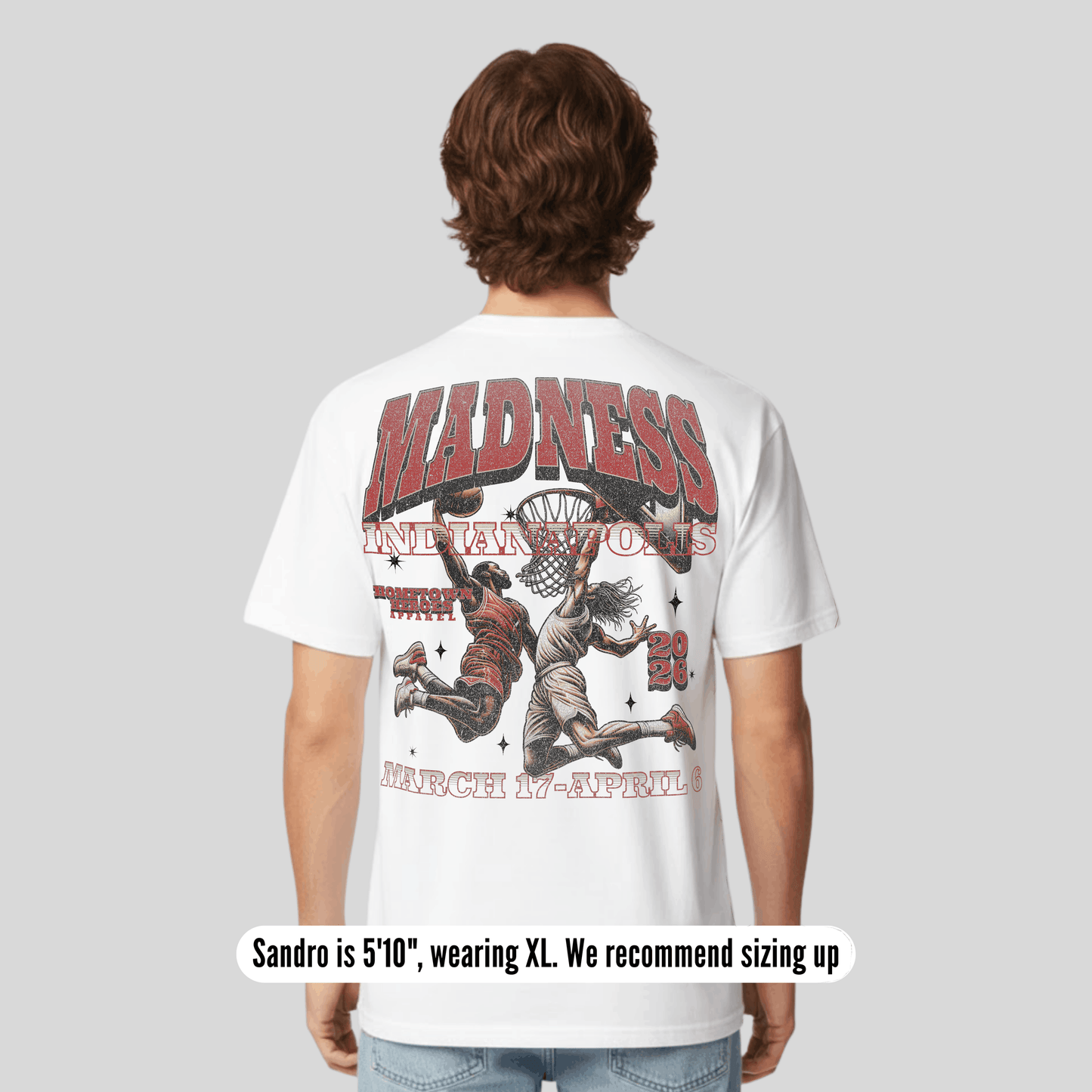 Person wearing a white t-shirt with graphic design and text on the back, on a plain background.