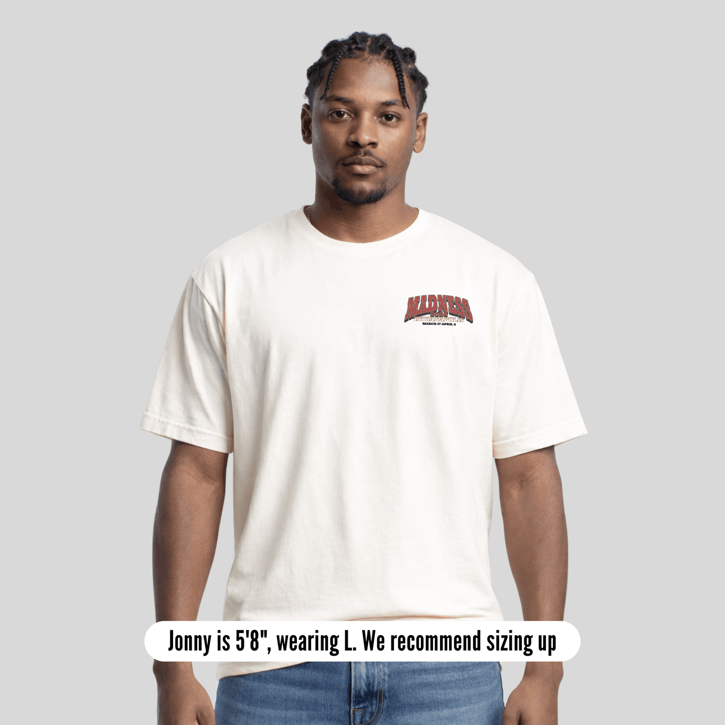 Man wearing a white t-shirt with red text on a gray background