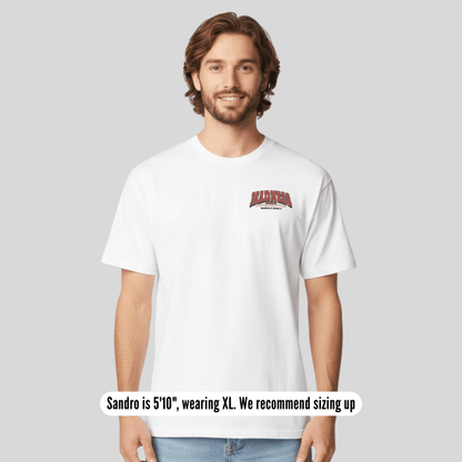 Man wearing a white t-shirt with red text on a plain background