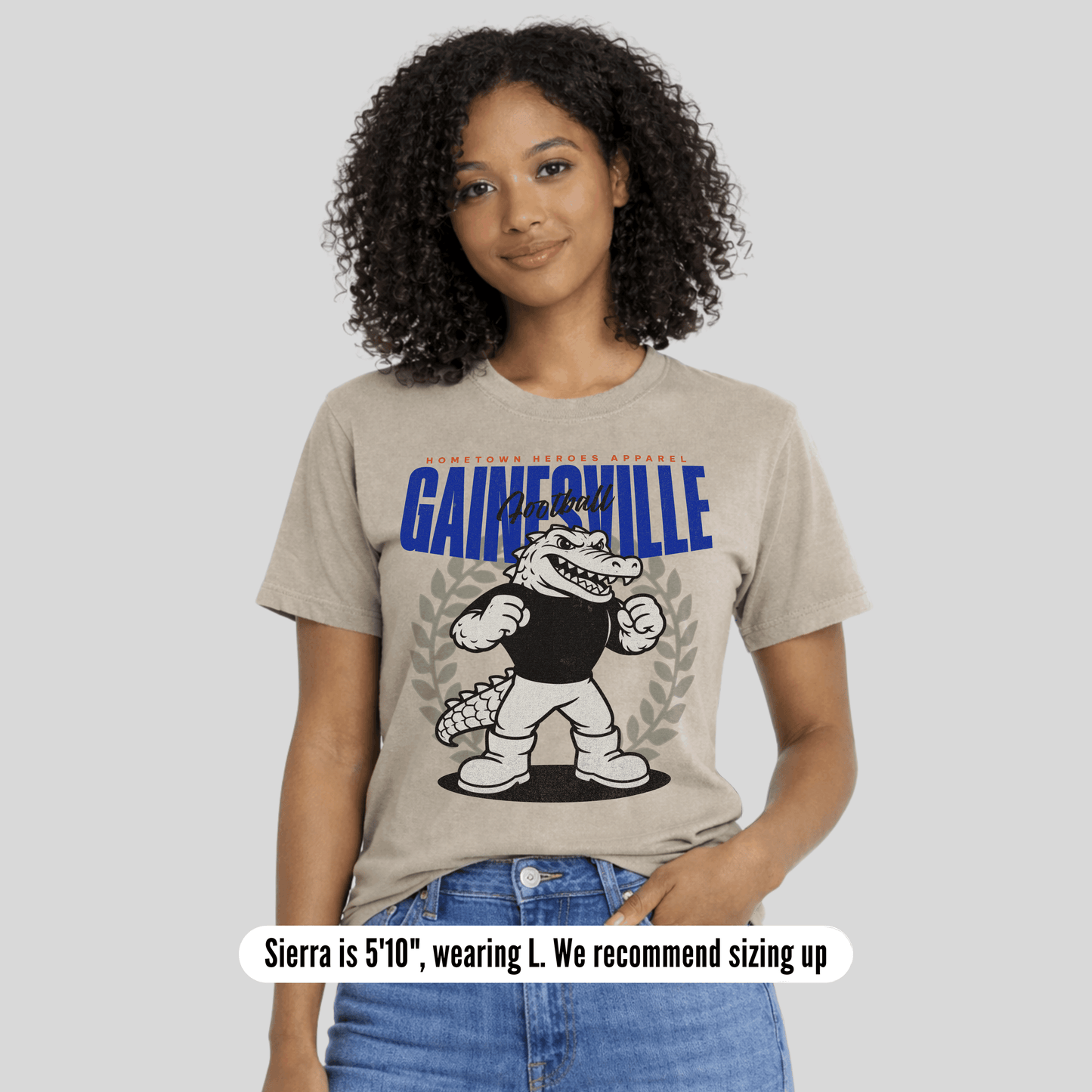 Woman wearing a t-shirt with 'Gainesville' and a cartoon character on a plain background
