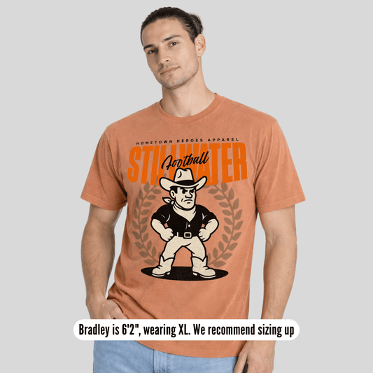 Man wearing a t-shirt with a graphic design and text on a plain background
