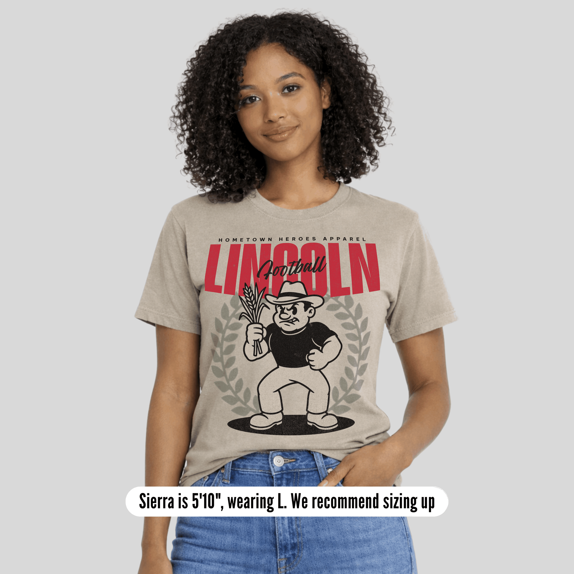 Person wearing a t-shirt with a graphic design and text, standing against a plain background.