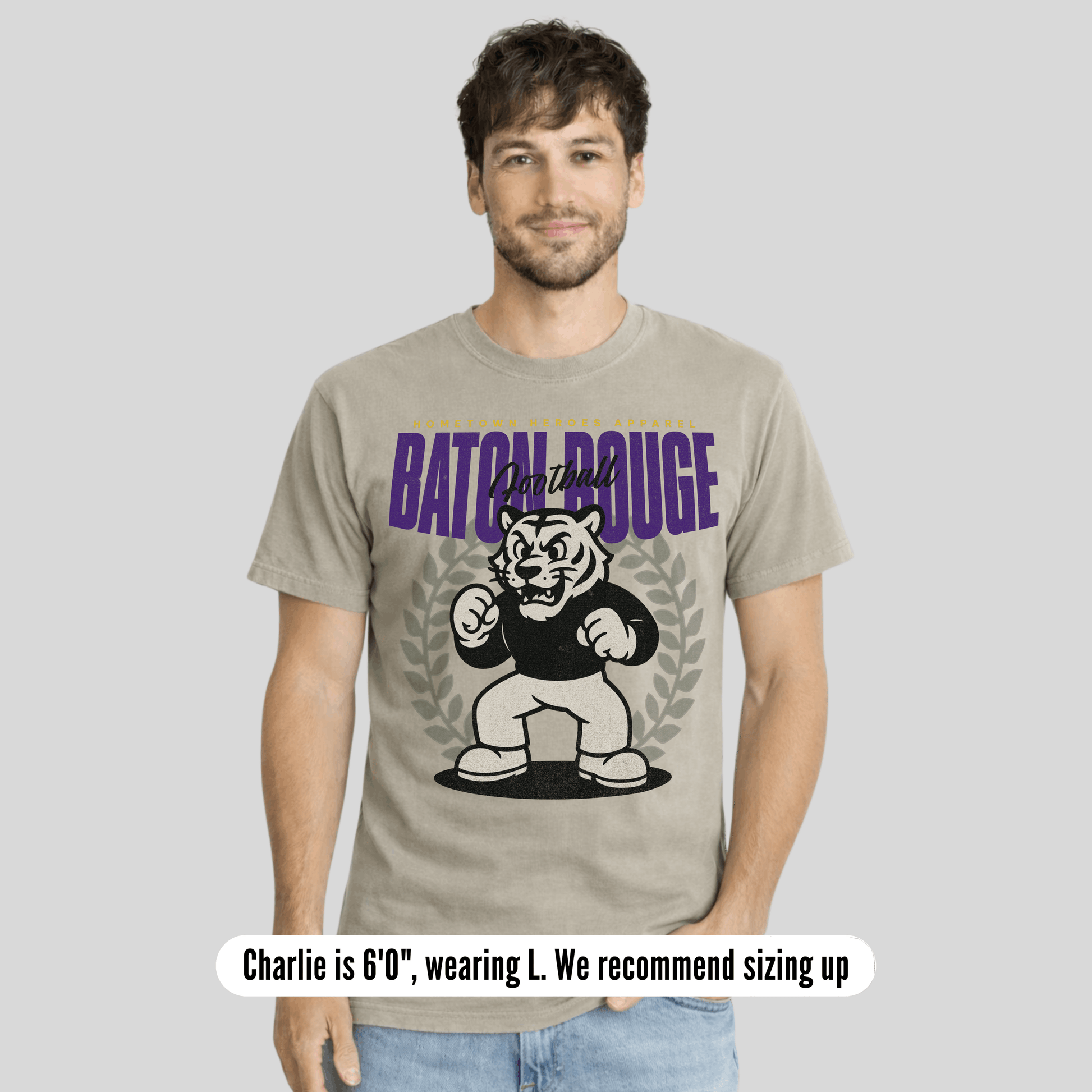 Man wearing a t-shirt with 'Baton Rouge' graphic design on a plain background
