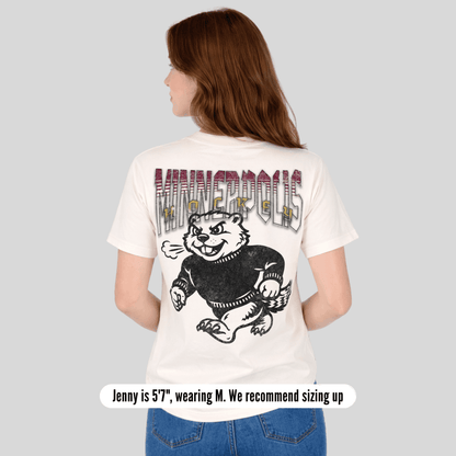 Person wearing a white t-shirt with a graphic design on the back, standing against a plain background.