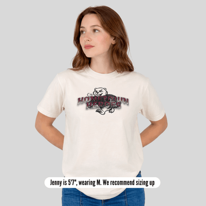 Woman wearing a white t-shirt with a graphic design on a gray background