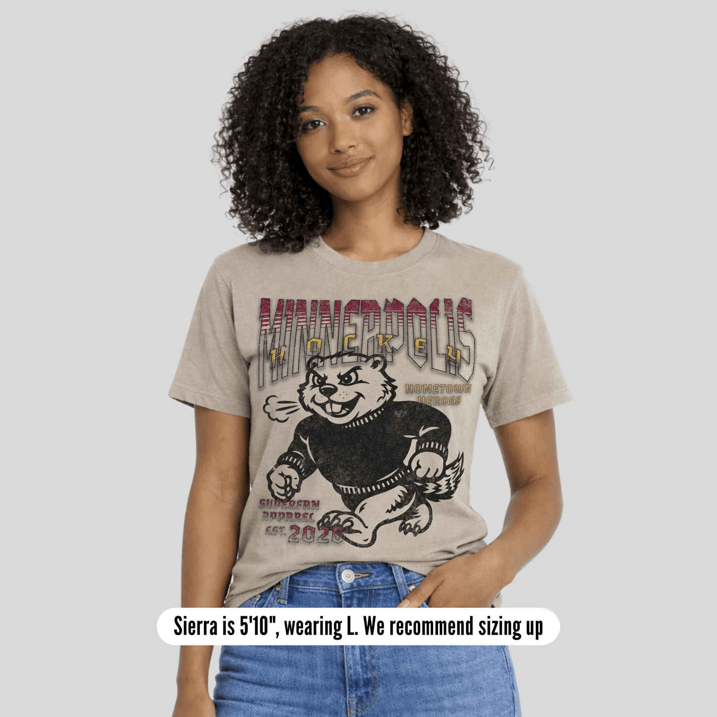 Woman wearing a t-shirt with a graphic design on a plain background