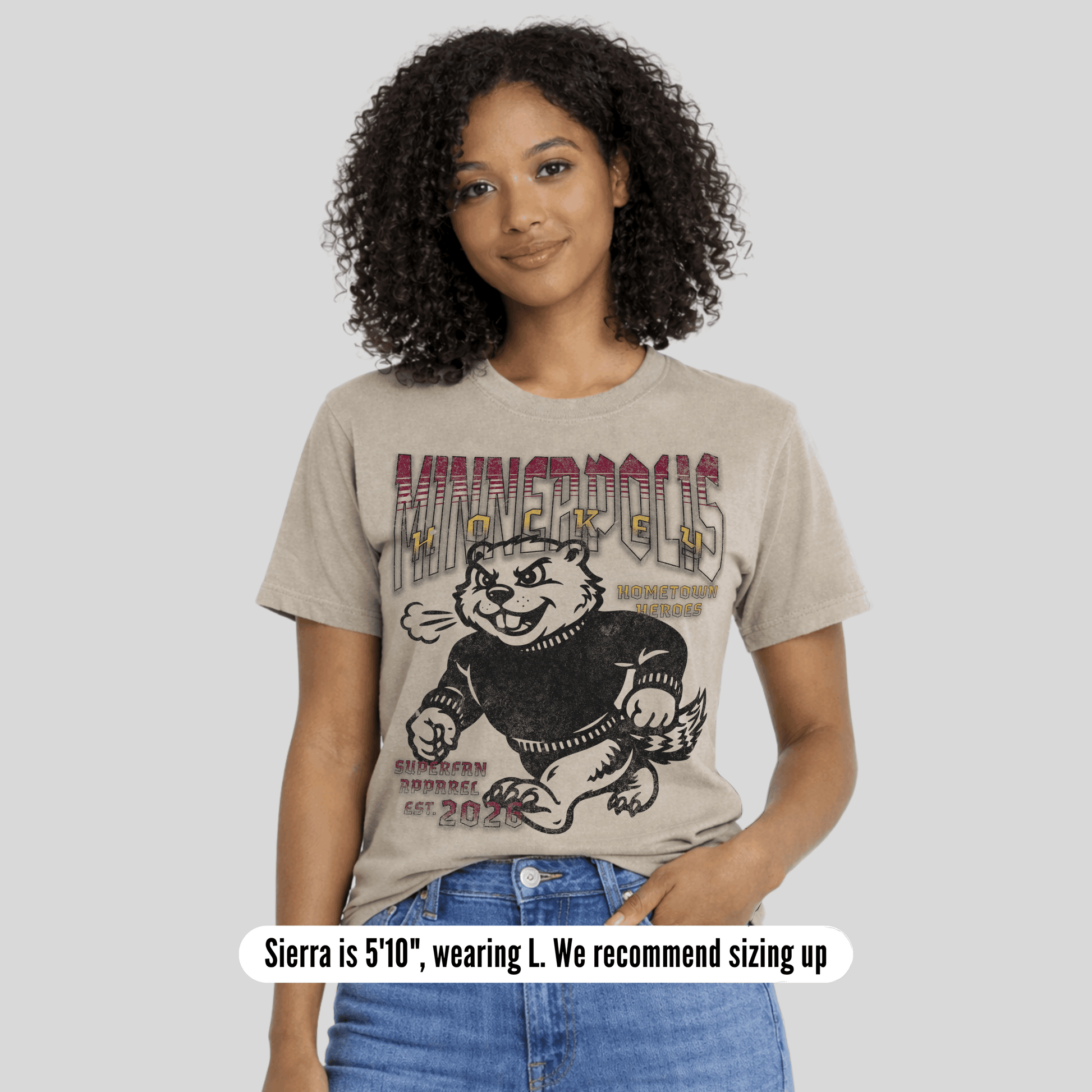 Woman wearing a t-shirt with a graphic design on a plain background